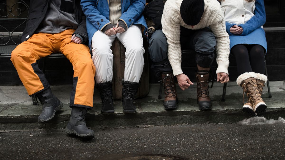 Overlook Boots shop -Overlook Boots shop friend sitting on bench man tying shoelaces royalty free image 1671123204